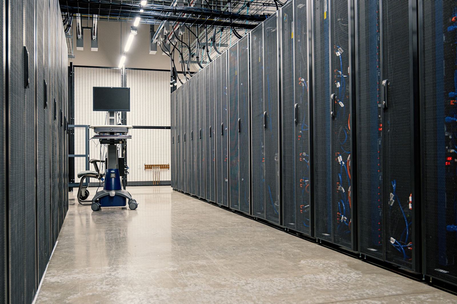An aisle of server racks inside a data centre