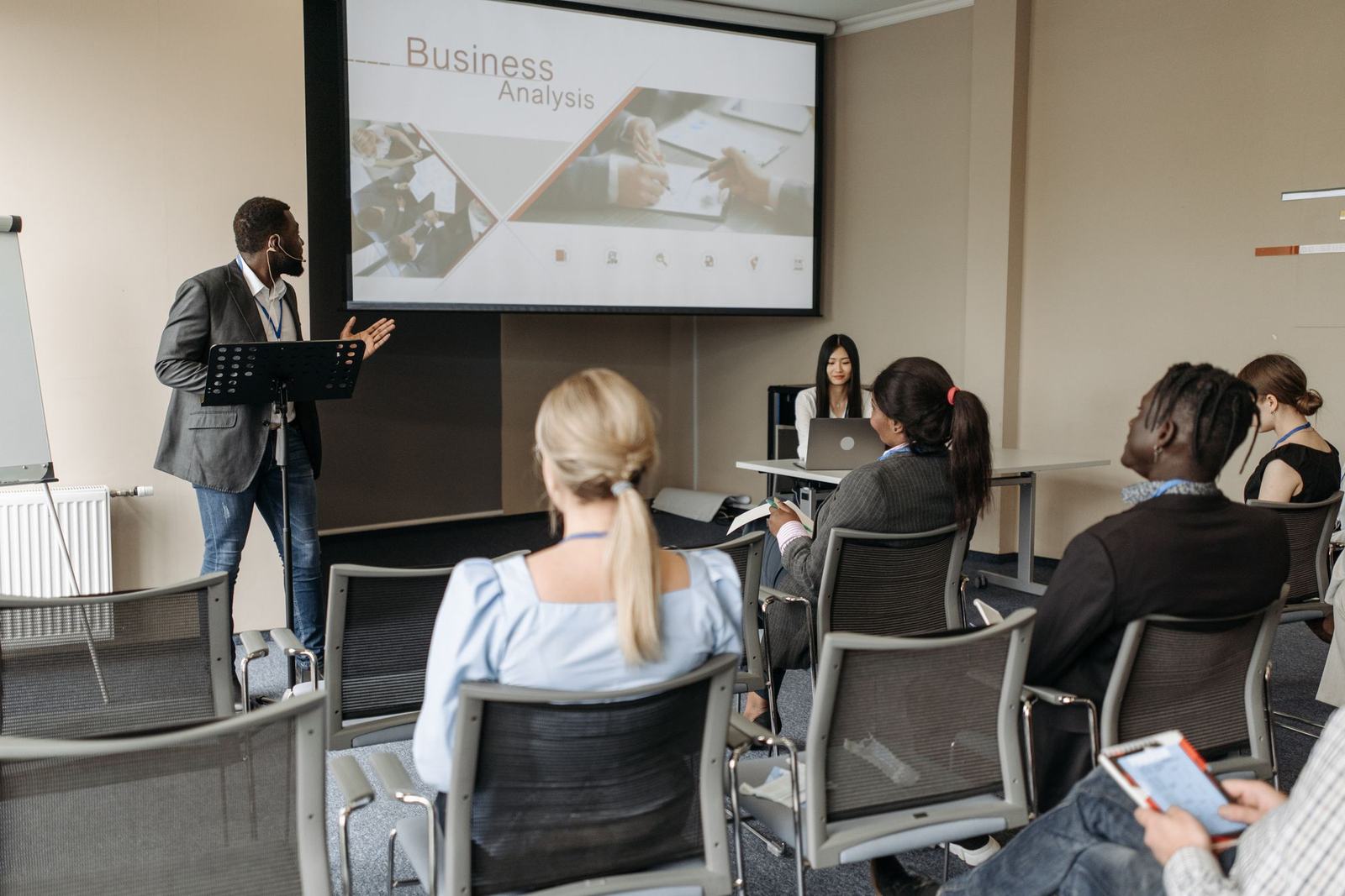 A presenter leading a session with a small seated group